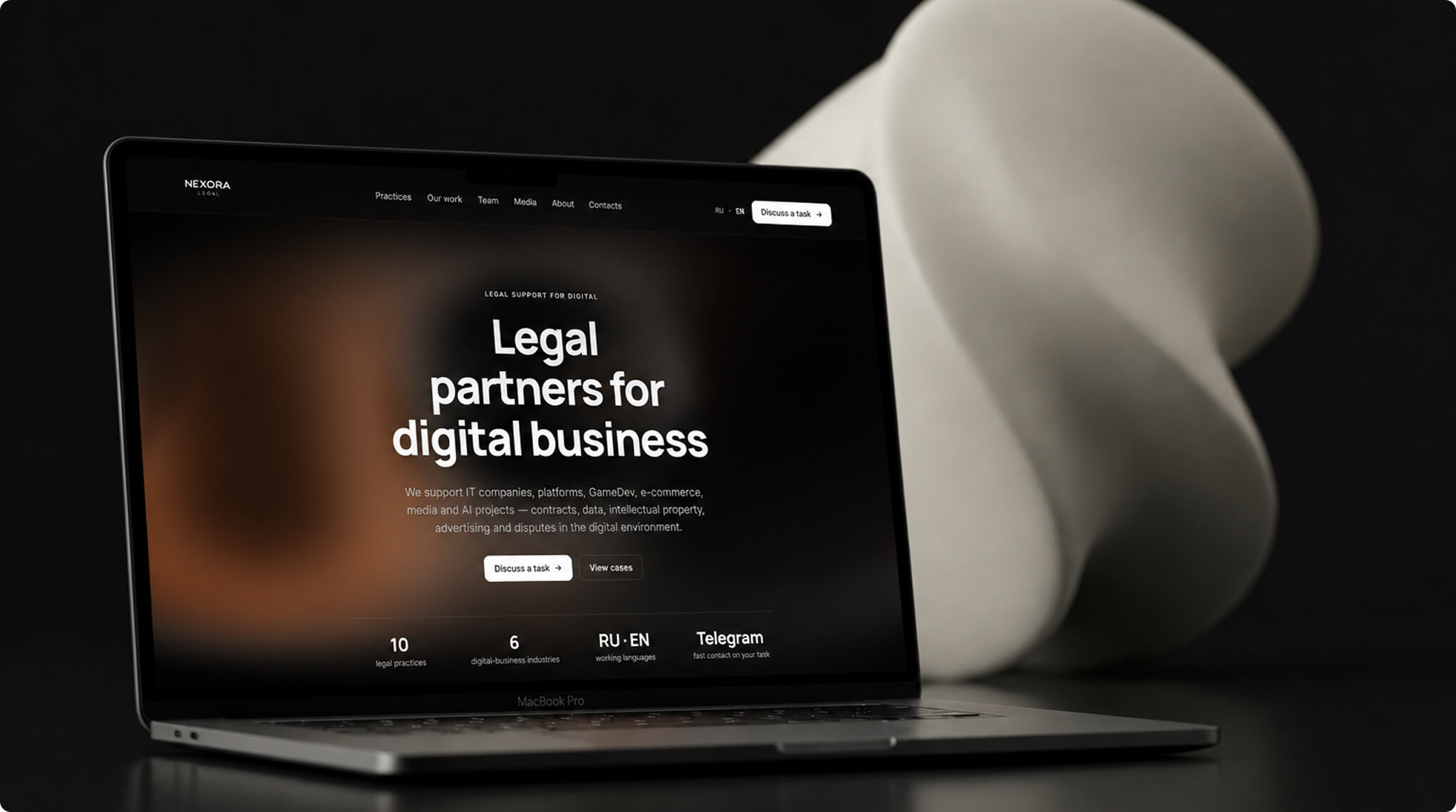 Nexora Legal — тёмная версия v2 сайта на MacBook